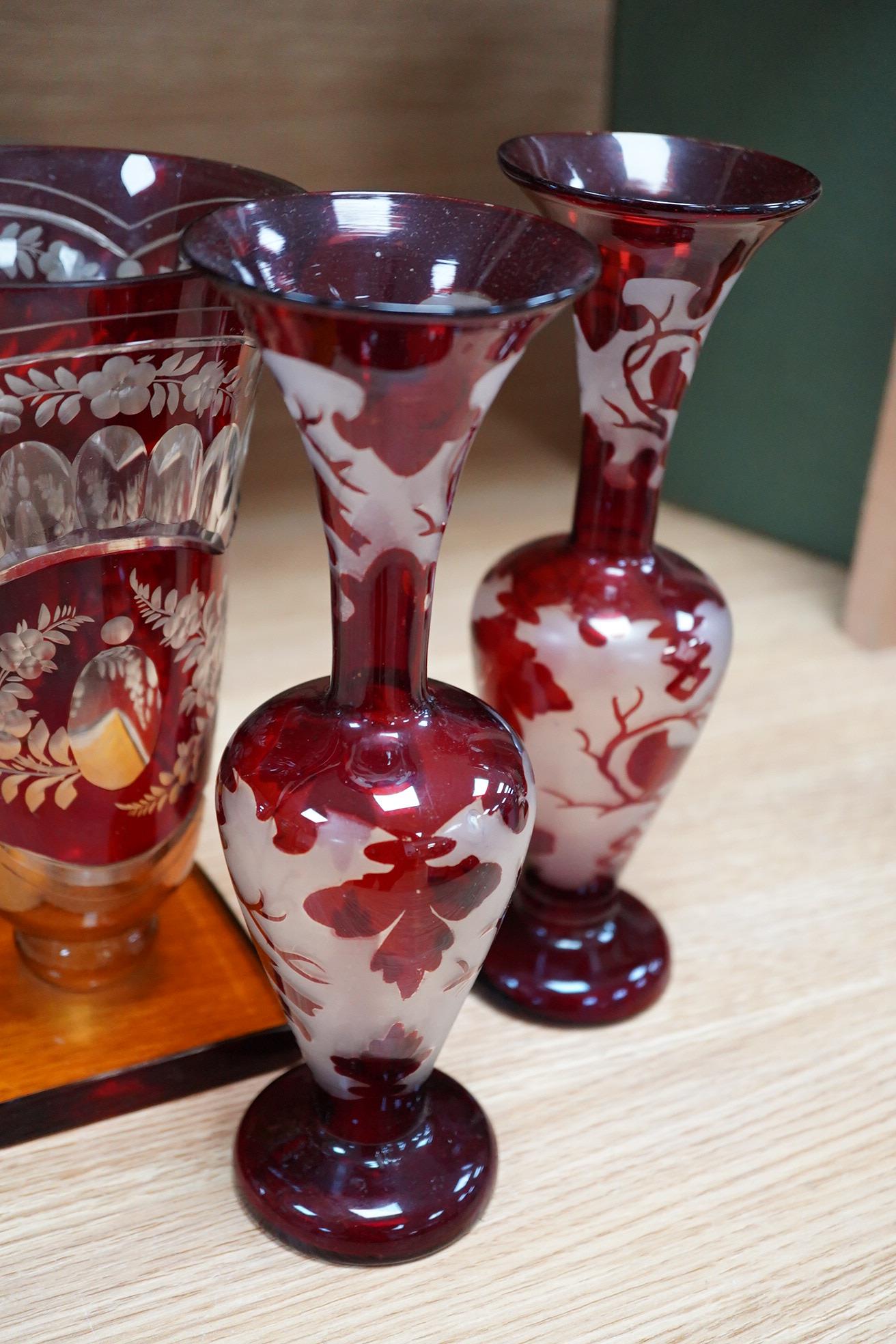 A Czechoslovakian red and amber cut glass square base vase, 21cm high and a pair of similar vases